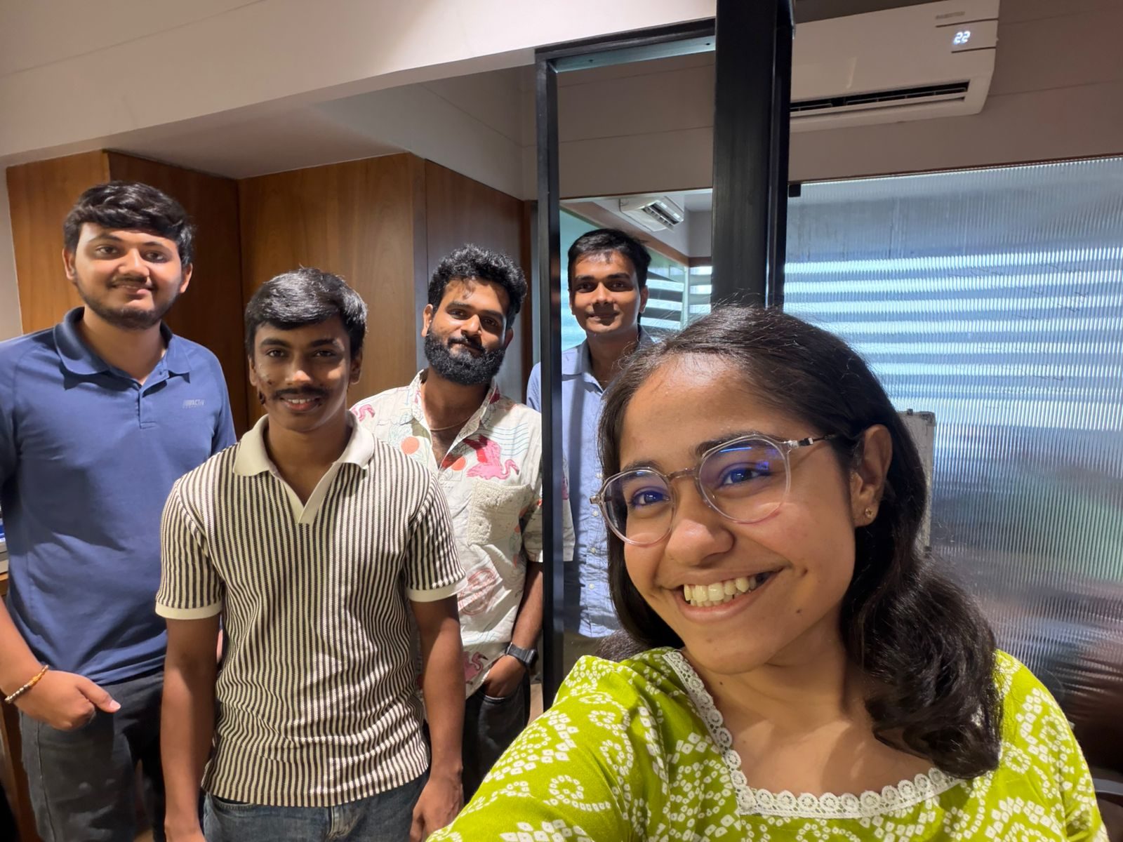 Five colleagues taking a quick office selfie in the Ahmedabad workspace