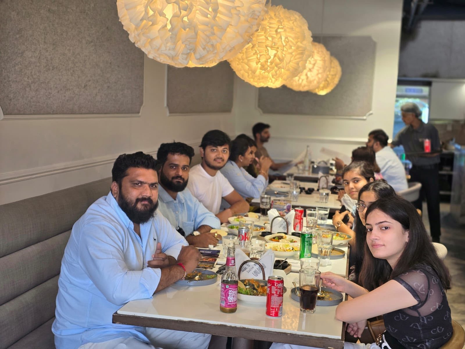 The KivvaTech team enjoying a sit-down lunch together at a restaurant, celebrating a milestone